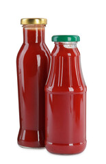 Different bottles of ketchup on white background
