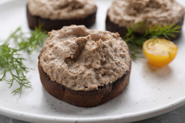 Slices of bread with delicious pate, tomato and dill on plate, closeup