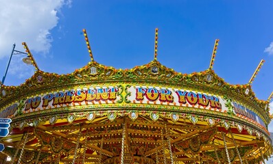 merry go round fun fair ride with blue sky background