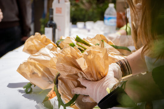 woman preparing paper bags with garlic bunches the market of the roasted garlic festival in  Arnedo, La Rioja Spain