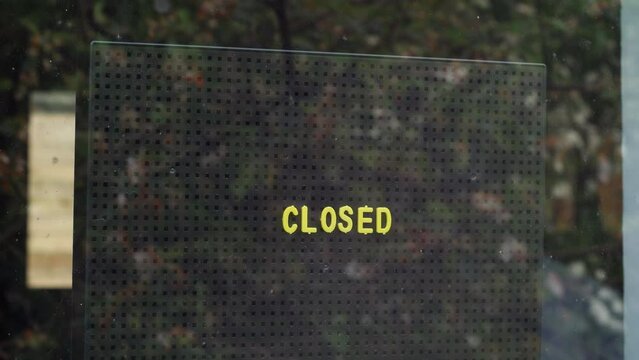 Placing a closed sign in the window.