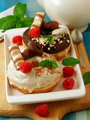 Big donuts with chocolate and raspberries.
