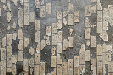 full-frame background and texture of damaged brick pavement.