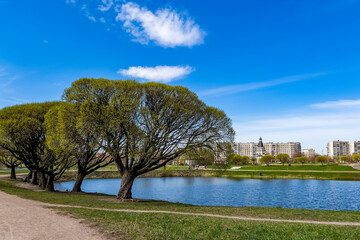 Saint Petersburg, Russia, May 10, 2022.  Multi-storey modern residential buildings near the pond