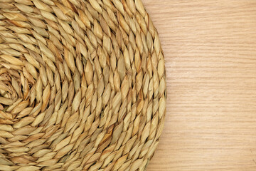 Dried Grass Straw Circular Woven Matt on Wooden Background