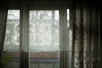 Window in room. Curtains on window.