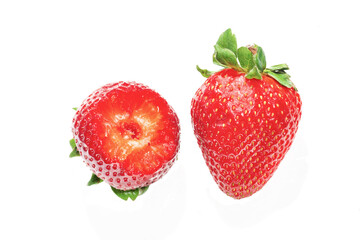 two ripe strawberries, one bite on white background
