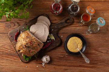 Crispy, cooked ham. Served with spices on a wooden board.