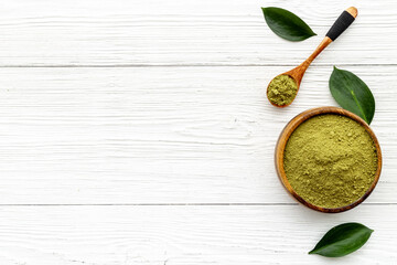 Matcha tea powder in bowl with leaf. Asian beverage concept