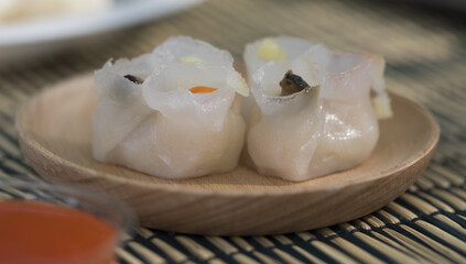 Dumplings on a wooden plate, Asian food, street food