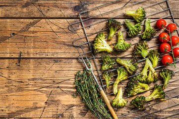Homemade Roasted broccoli cabbage on grill. Wooden background. Top view. Copy space