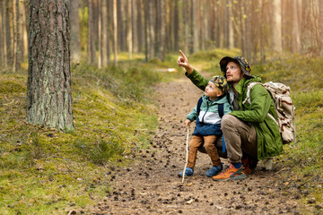 father and son adventure hike. exploring forest together. bonding activities - obrazy, fototapety, plakaty
