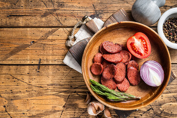 Turkish breakfast with Fried sausage sucuk on a rustic plate. Wooden background. Top view. Copy space