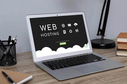 Web hosting service. Comfortable workplace with modern laptop on wooden table