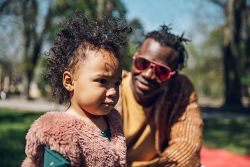 African american father spending time with his daughter in the park