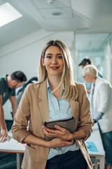 Businesswoman posing and smiling during a meeting in an office