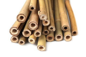 Pile of dry bamboo sticks on white background, closeup