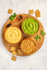 Flatlay of vegetarian hummus in bowls with chickpeas