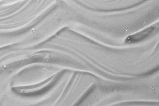Texture of transparent shower gel on white background, closeup
