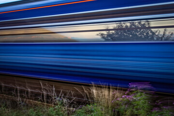 Close view of high speed train passing by with motion blur