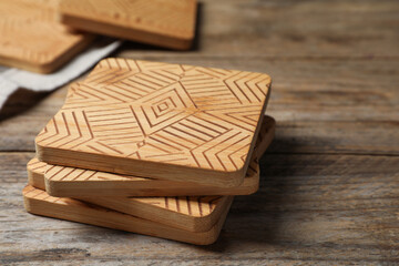 Stylish cup coasters on wooden table, closeup. Space for text
