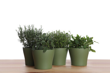 Pots with thyme, sage, mint and rosemary on wooden table against white background