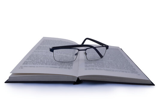 Pair of Glasses on Book