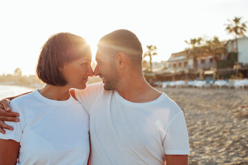 Happy portrait couple in love on the beach. Mixed family. Diverse couple on summer vacation