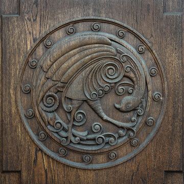 wooden bas-relief depicting a peacock