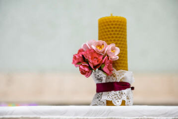 Wedding candle decorated with ribbon and flowers