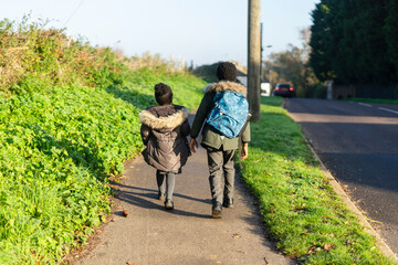 Siblings walking to school