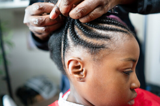 Girl having hair braided