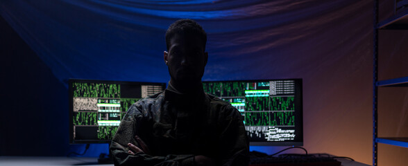 Fototapeta Anonymous hacker in military unifrorm on dark web, cyberwar concept. obraz