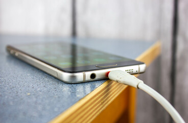 Smartphone charging.Phone charging cable close-up.