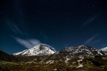 Fototapeta na wymiar night sky stars milky way blue purple sky in starry night over mountains. Night landscape with a mountain lake and a starry sky. stars over Himalaya mountains. 