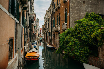 Fototapeta na wymiar Traditional narrow canal street with old houses in Venice, Italy. Italy beauty, one of canal streets in Venice, Venezia