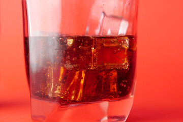 soft drinks with ice on red background 