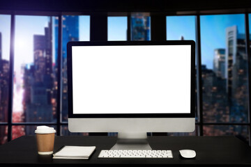 Fototapeta premium Workspace with computer Monitor, Keyboard, blank screen coffee cup smartphone, and tablet on a table or White Screen Isolated in bright office