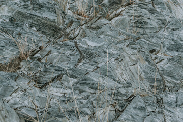 Slate stone wall as background. Textured surface of geological layer of soil
