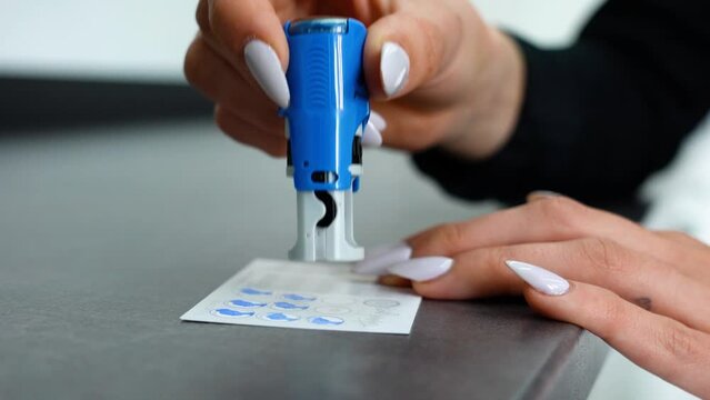 Stamping a coupon card at a beauty center - steady shot
