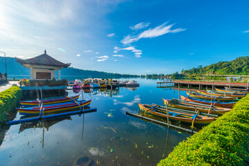 Beautiful morning over a wooden traditional boat at Beratan lake, one of famous tourist attraction...