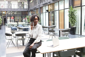 Businesswoman talking on phone in office