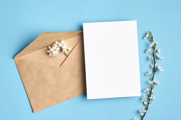 Blank invitation card mockup with envelope and flowers