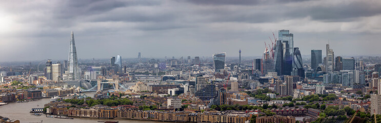 Fototapeta na wymiar Elevated panorama of the London skyline from London Bridge to the City during a moody day with gray clouds, England
