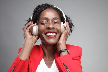 Smiling businesswoman listening to music on headphones