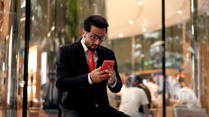 Young Businessman happy with Good News on Mobile phone