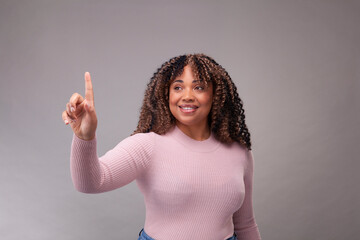 Smiling woman pointing up