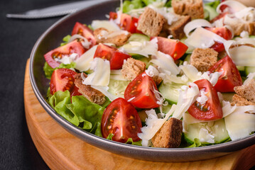 Delicious spring fresh vegetable salad with cherry tomatoes, cucumber, breadcrumbs and parmesan cheese