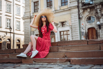 Summer fashion. Stylish girl in red polka-dot dress