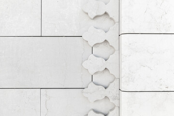White marble wall, corner decoration. Abstract Arabic pattern